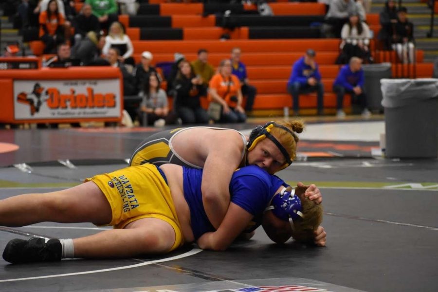 Willie Katchmark (11) pins an opponent in a sections tournament.
