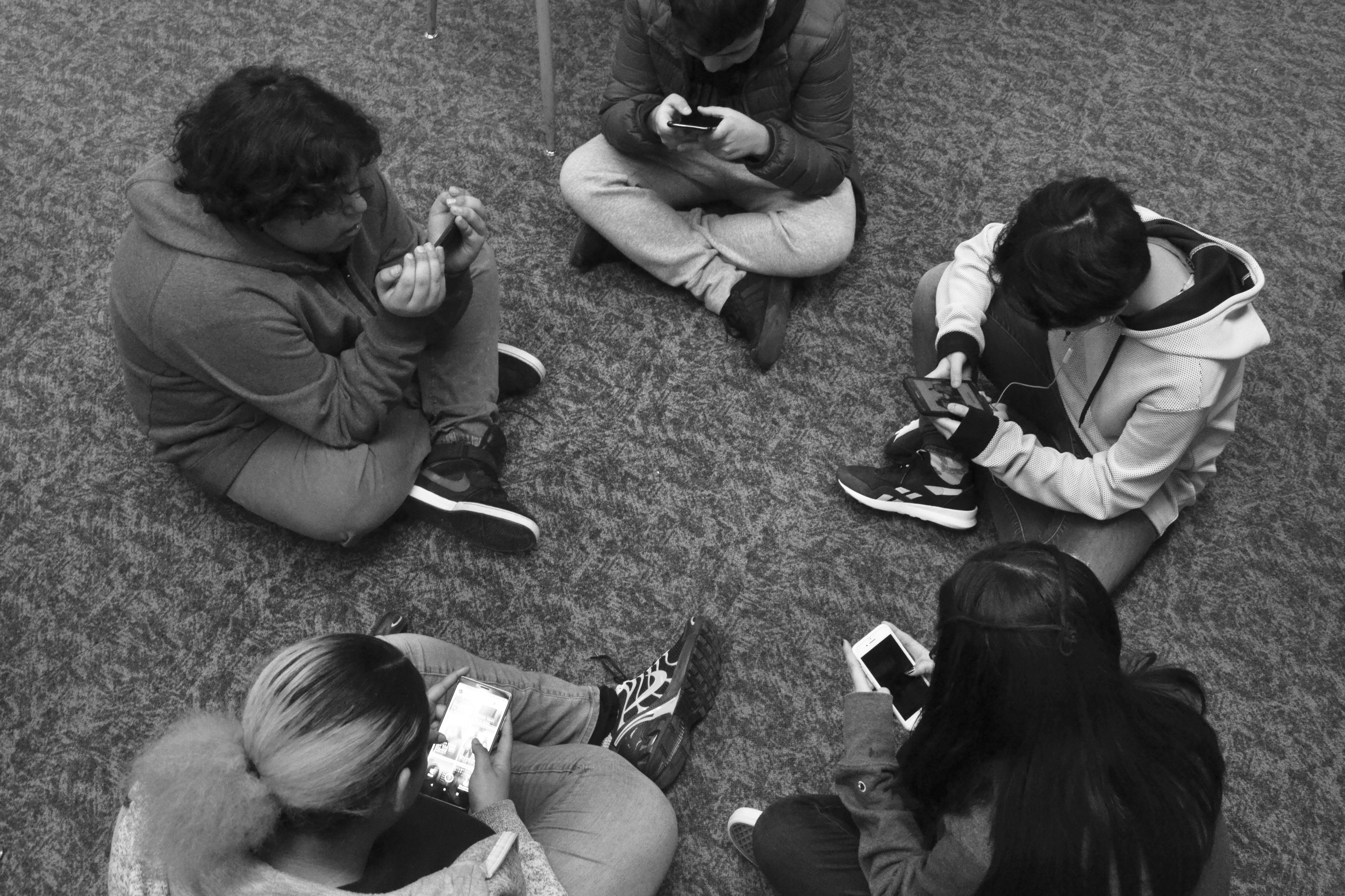 Teenagers using their phones.