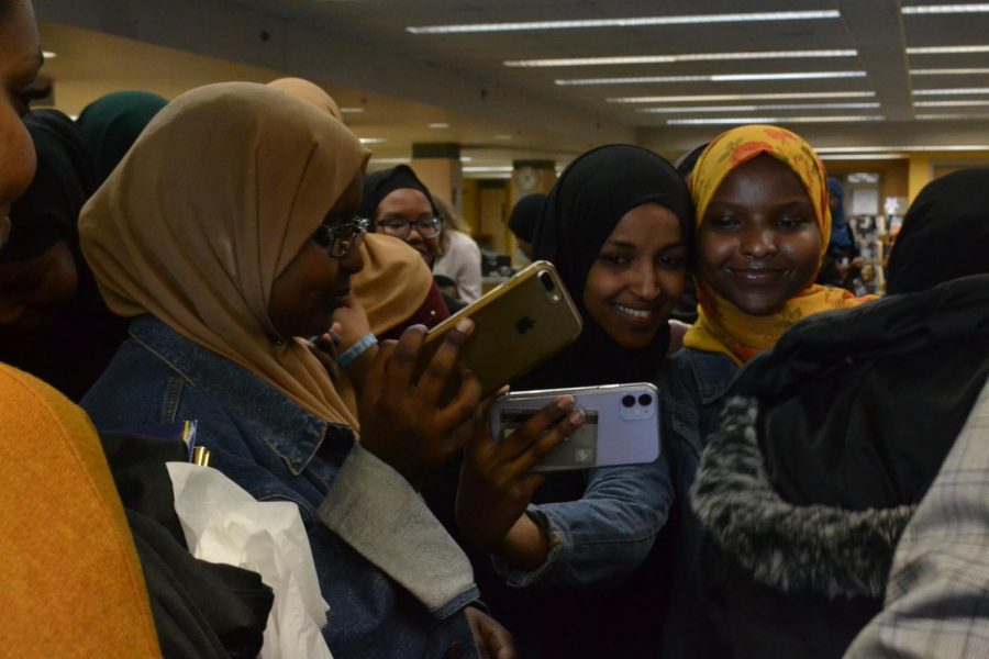 Students take selfies with Omar after hearing her speak. 