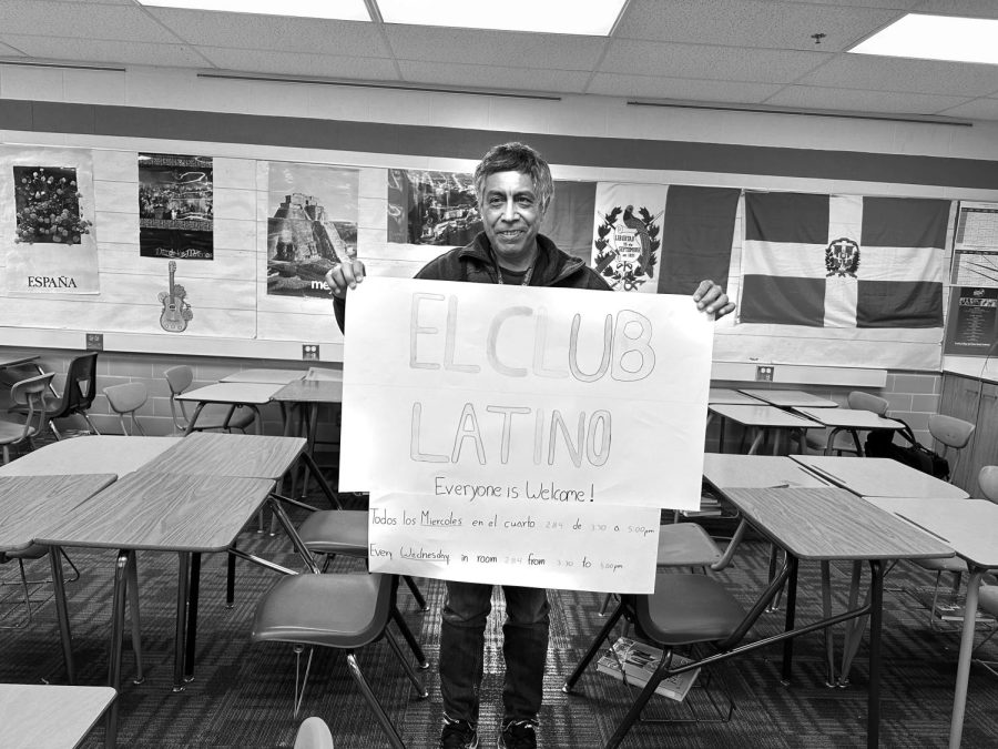 Julio+Batres+proudly+holds+a+student-created+poster+for+the+El+latino+club+at+CHHS.