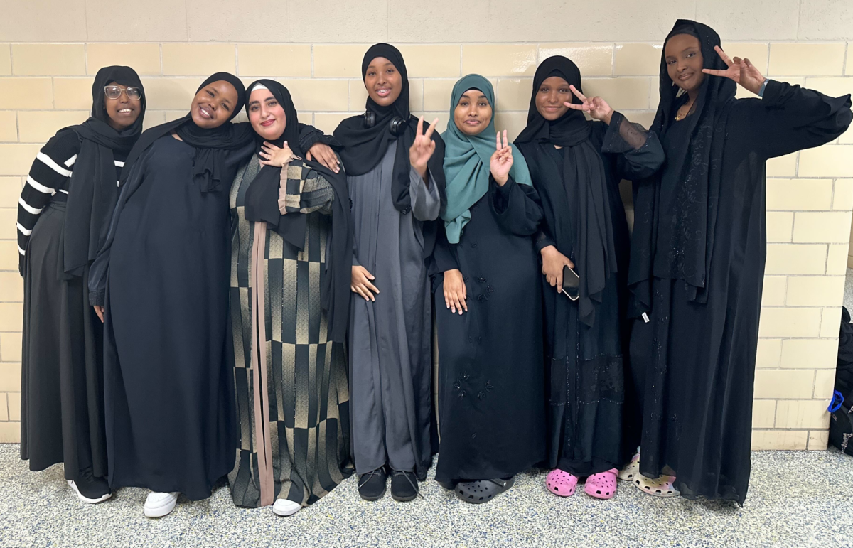 Several Abaya-wearing CHHS students, L-R: Isniina Mohamed (11), Rahma Hassan (11), Menatallah Elbadawi (11), Amina Ibrahim (11), Nawal Mohamed (!1), Nesra Omer (11) and Munira Ali (11), display the cultural prevalence of their faith.