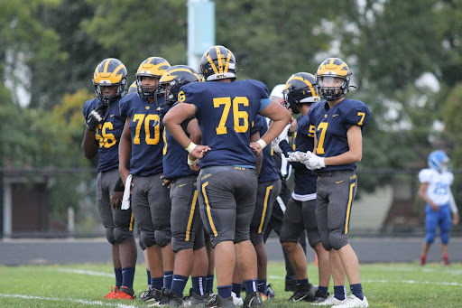 The offense huddles up after a play during a regular season game against Twin Cities Charter.