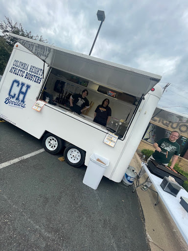 Feature Editor Skylen Raleigh and Staff Writer Finn Knoke-Borris volunteer at the Columbia Heights Activities Boosters hot dog wagon with Adviser Chris Polley to fundraise for The Heights Herald in 2024.
