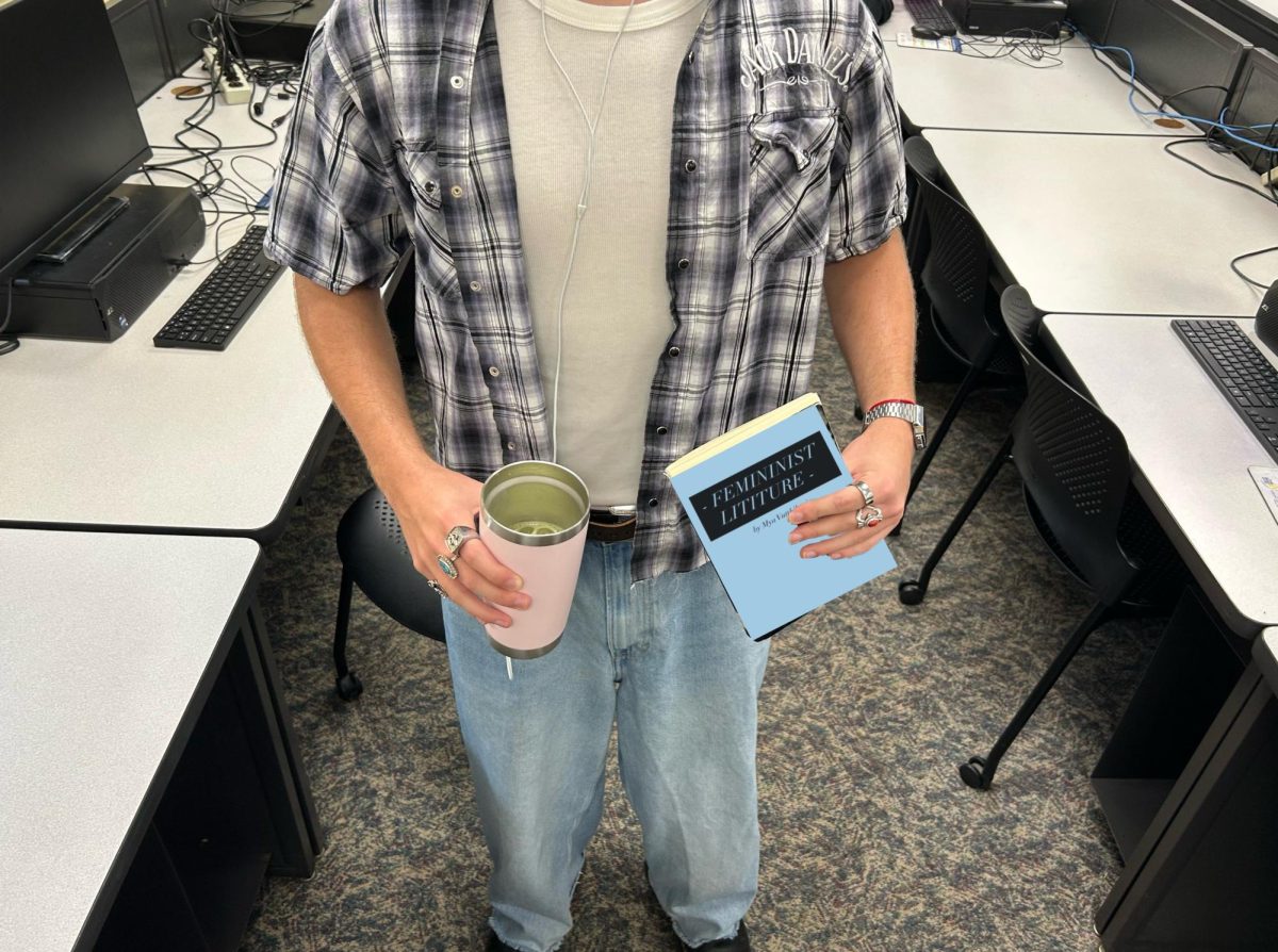 A performative male holds his matcha and feminist literature. (He's 6'4" by the way.)