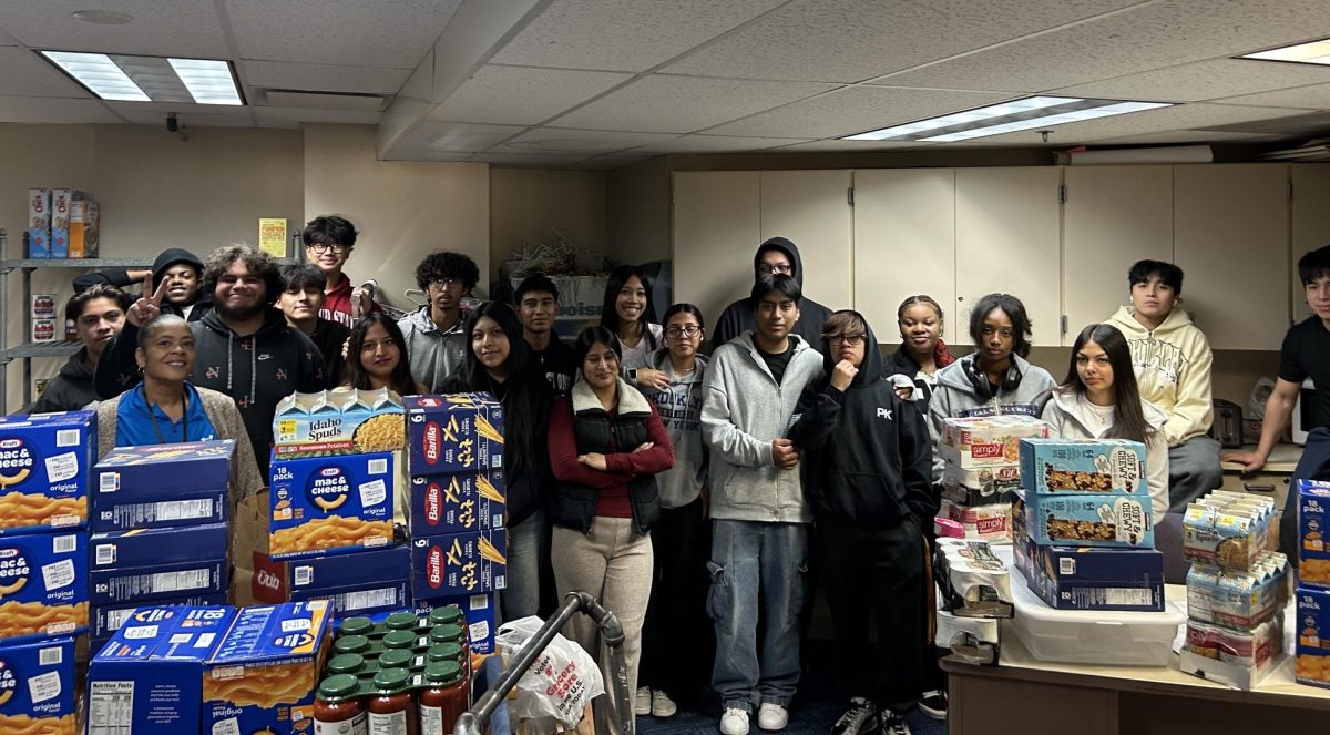 Ms. Moore and some helpful Hylanders stock up on non-perishable food in the Media Center for anyone in need.
