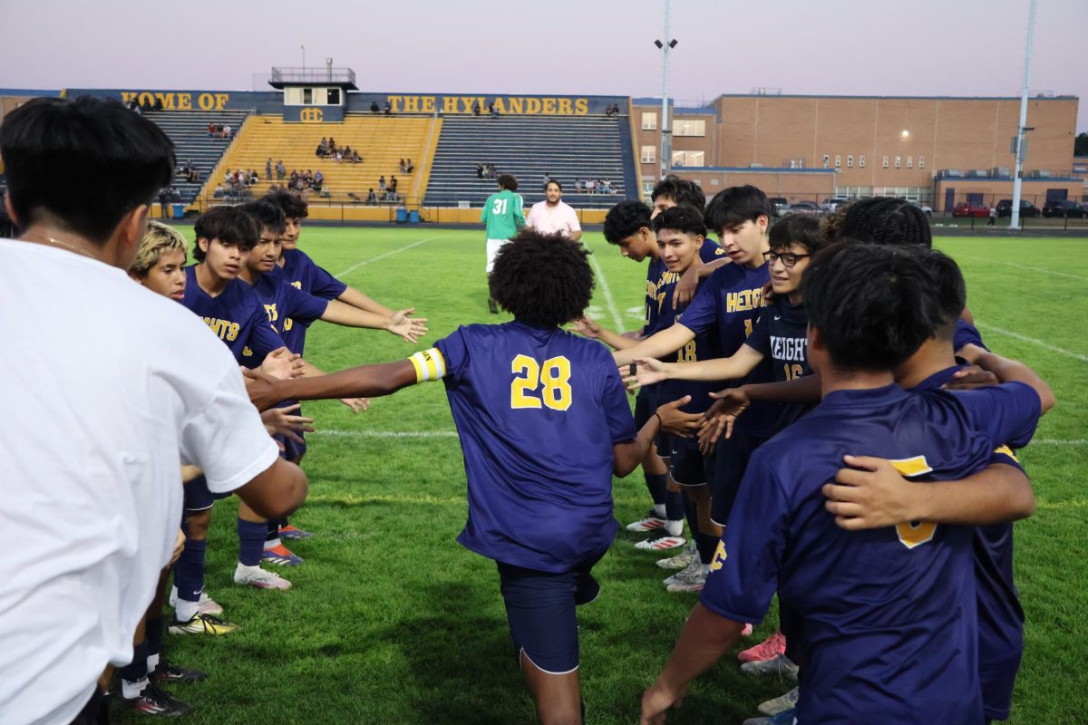 Soccer star Amjad Mohamed (12) runs through a line of high-fives from his teammates as they hype up for a game!