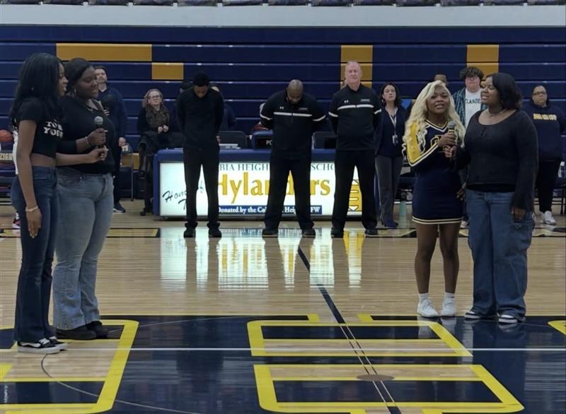 Black Student Union (BSU) members Ja'sirah Barber (12), Mariah Barber (12, Newte Roberts (12), and BeGlad Kansongoma (12) belt out the Black National Anthem in the main gym.