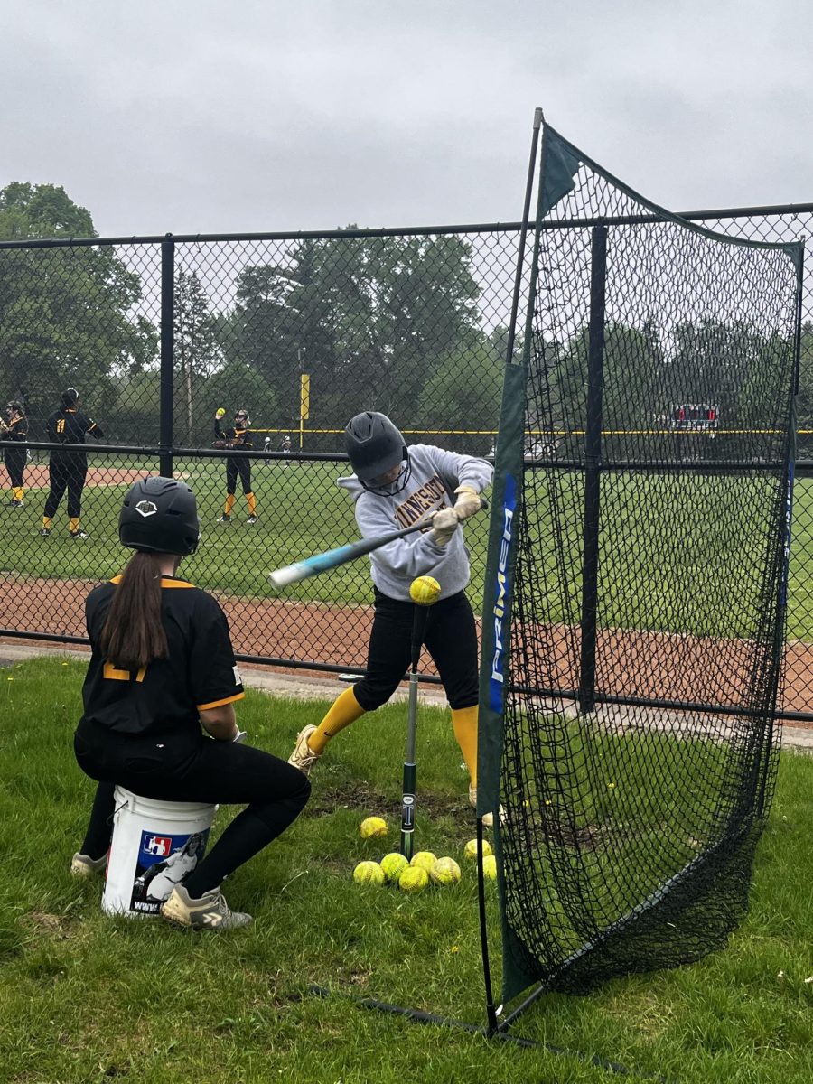 Softball player practicing their batting skills