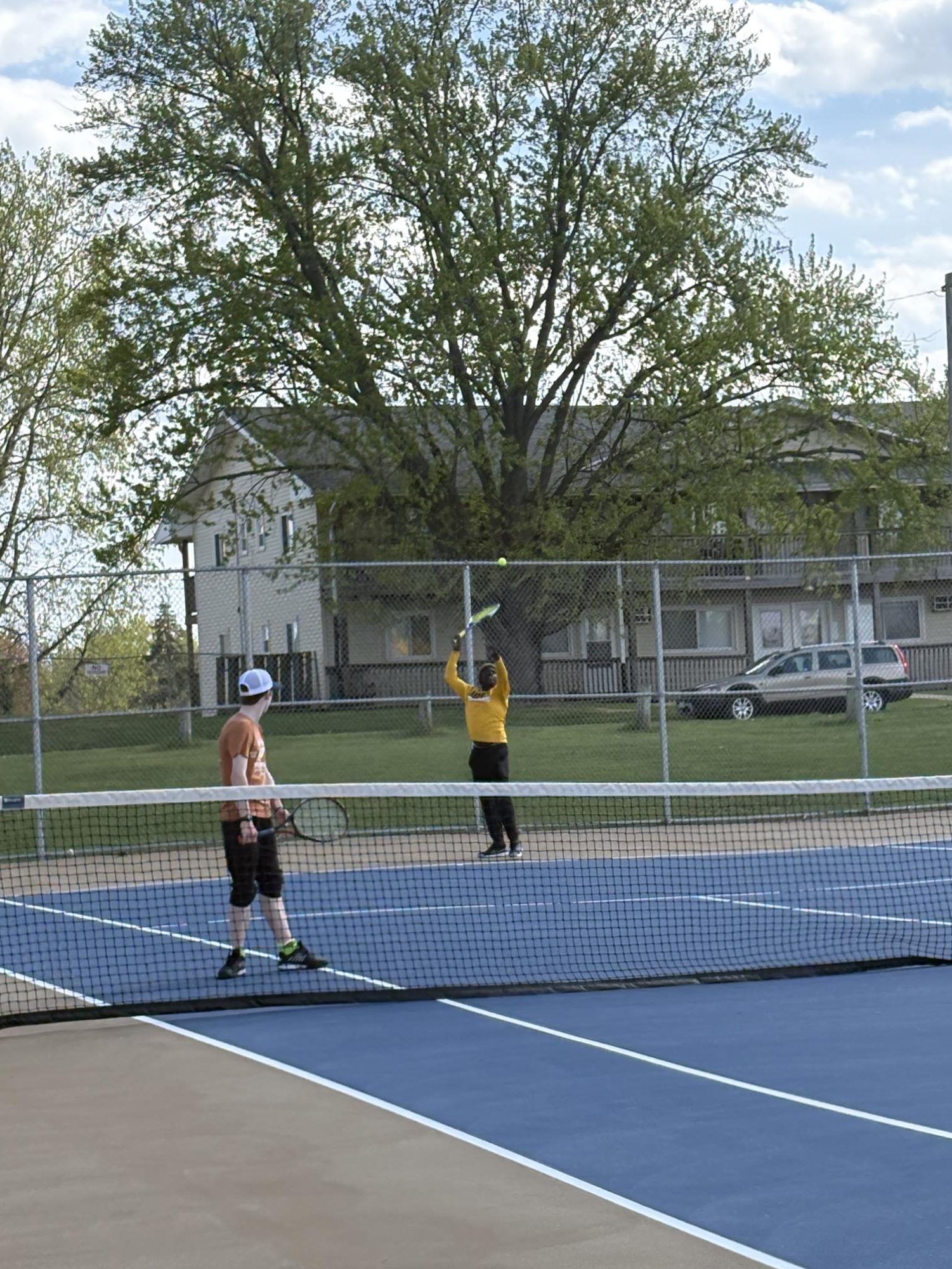 Tennis players doing practice matches.